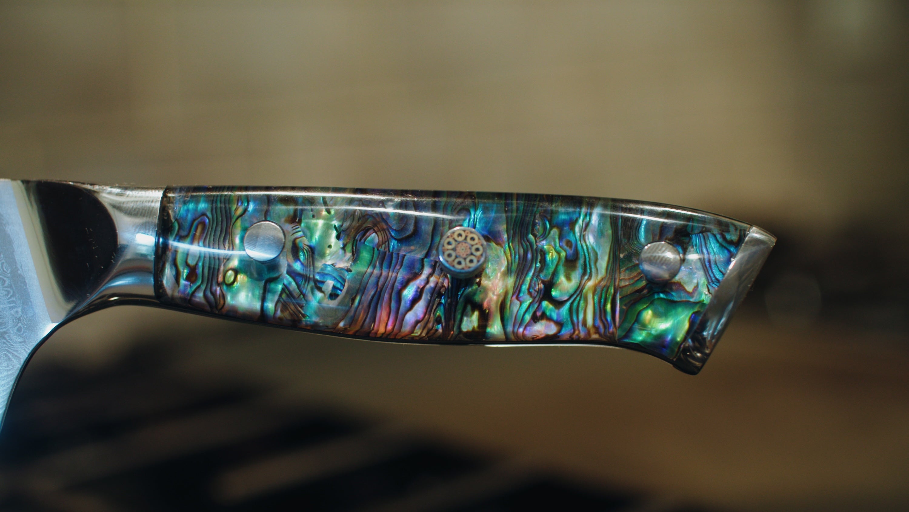 the abalone inlay of a handle is shown - its very pretty