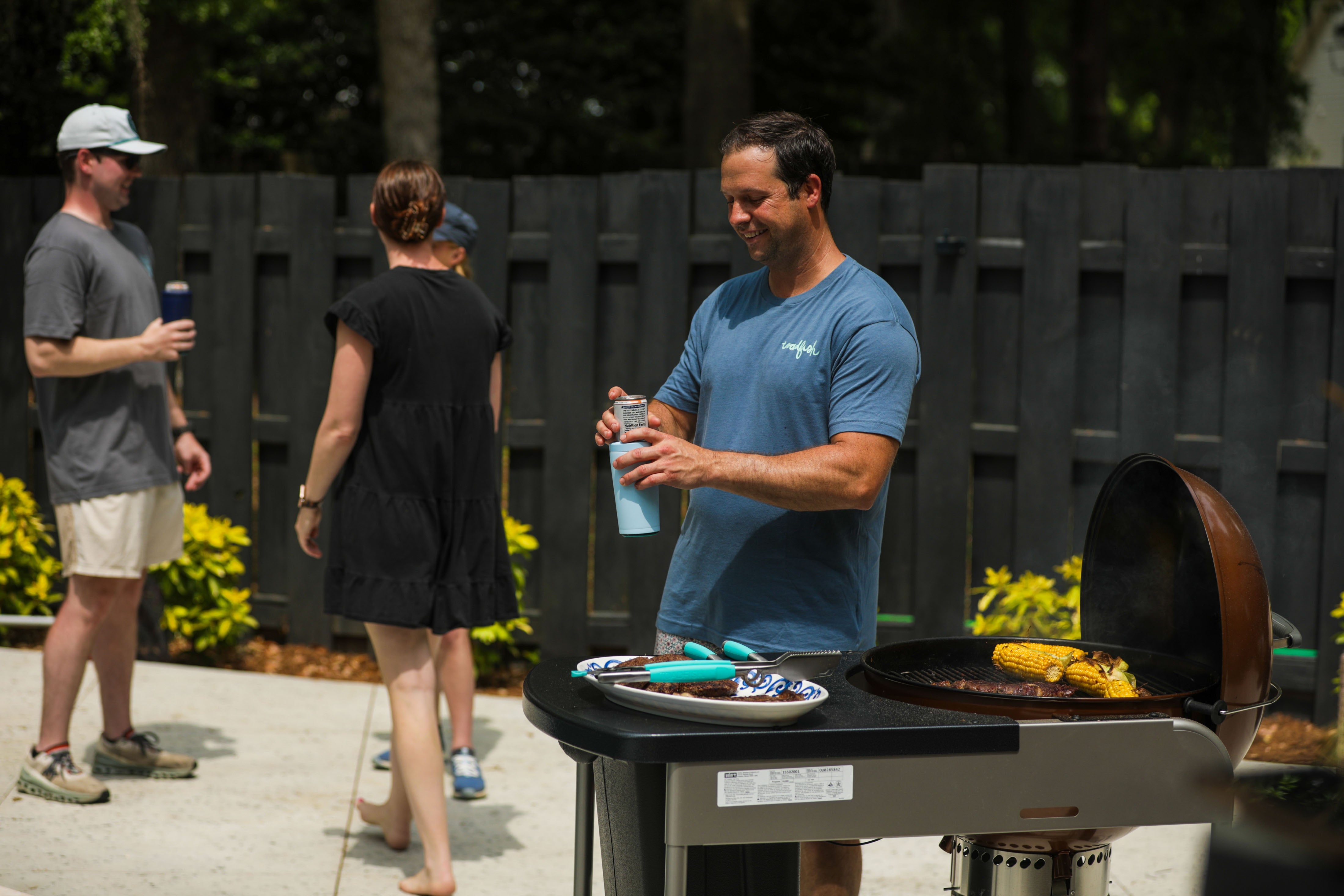 a man is grilling out with friends