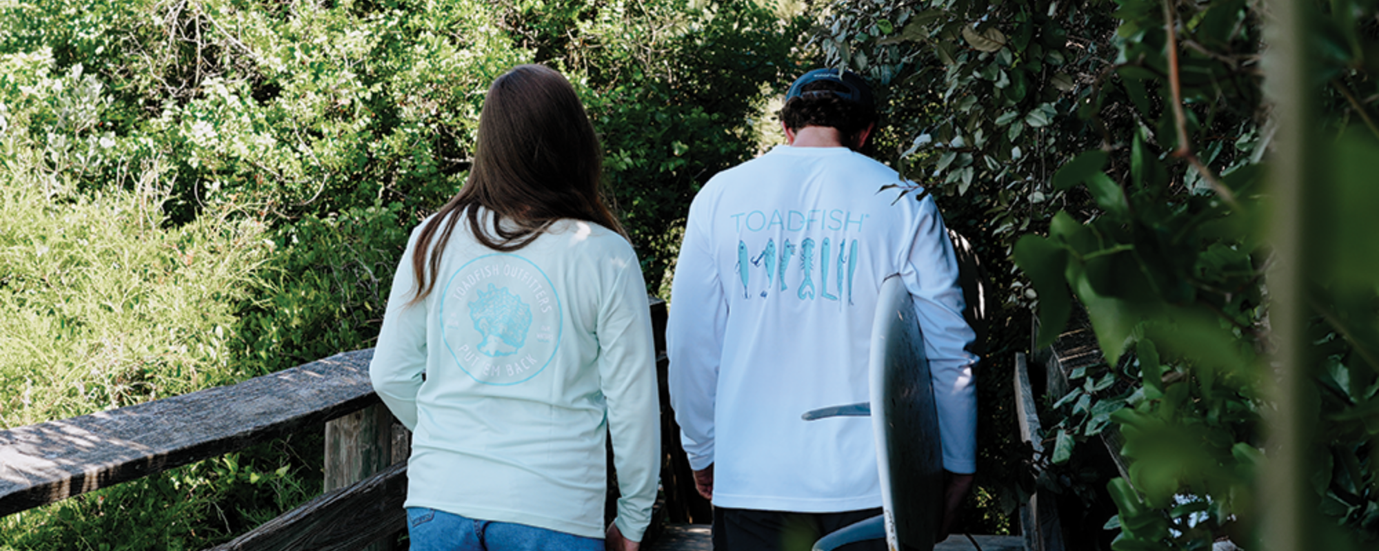 Two people are walking sporting new technical performance shirts from Toadfish