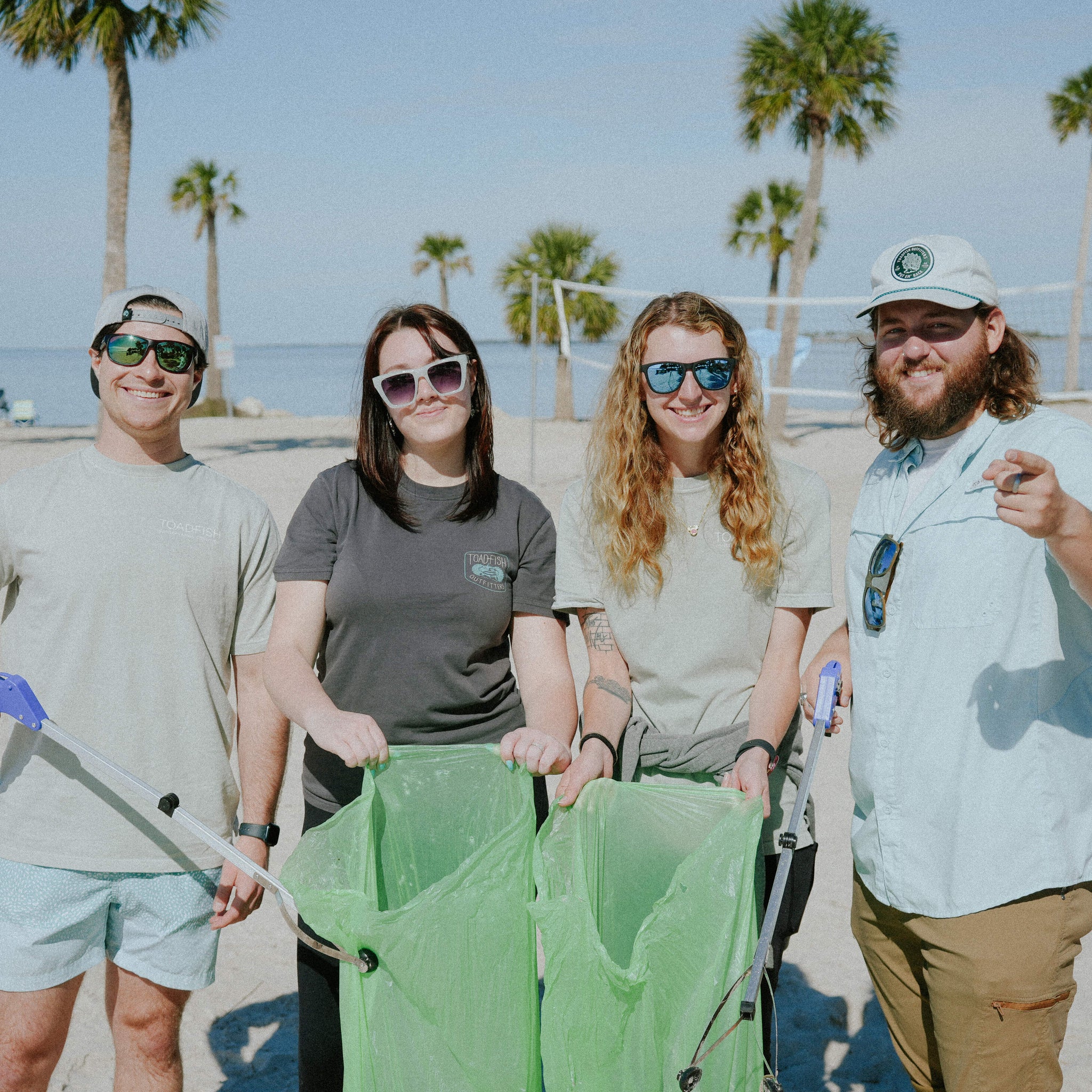 A group of people are at a beach clean-up