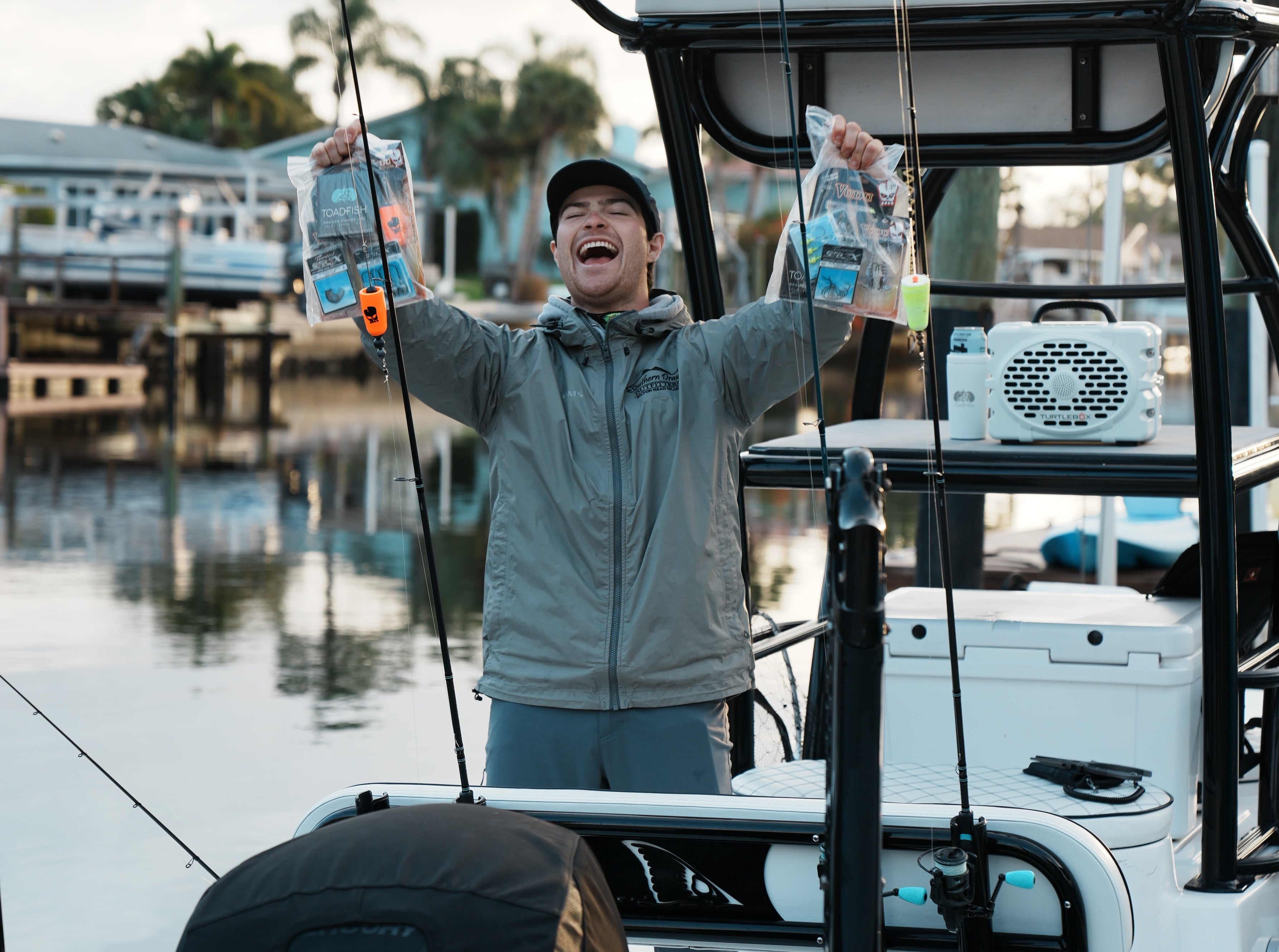 a man is overjoyed about the launching of the inshore bundle! he's holding up two inshore bundles in his hands and he is so excited