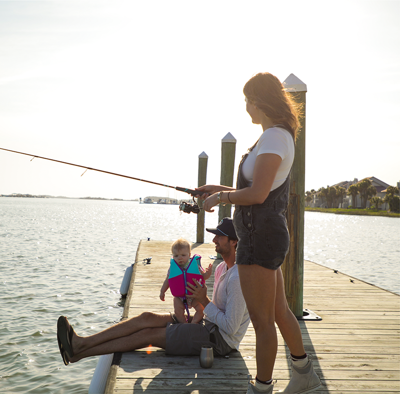 Family fishign on a dock with a baby