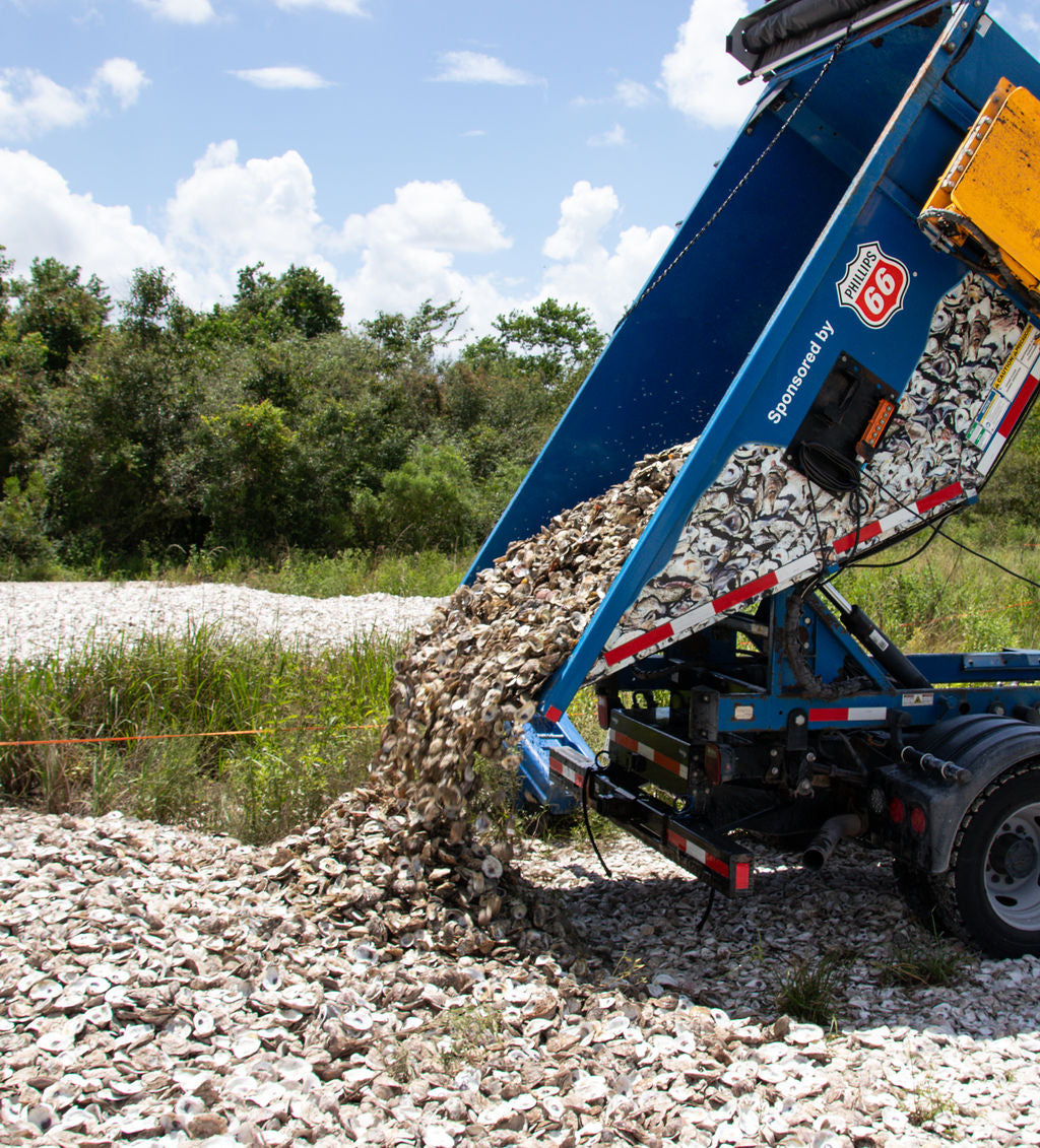 BIG TRUCK DUMPING OYSTER SHELLS FROM GALVESTON BAY FOUNDATION