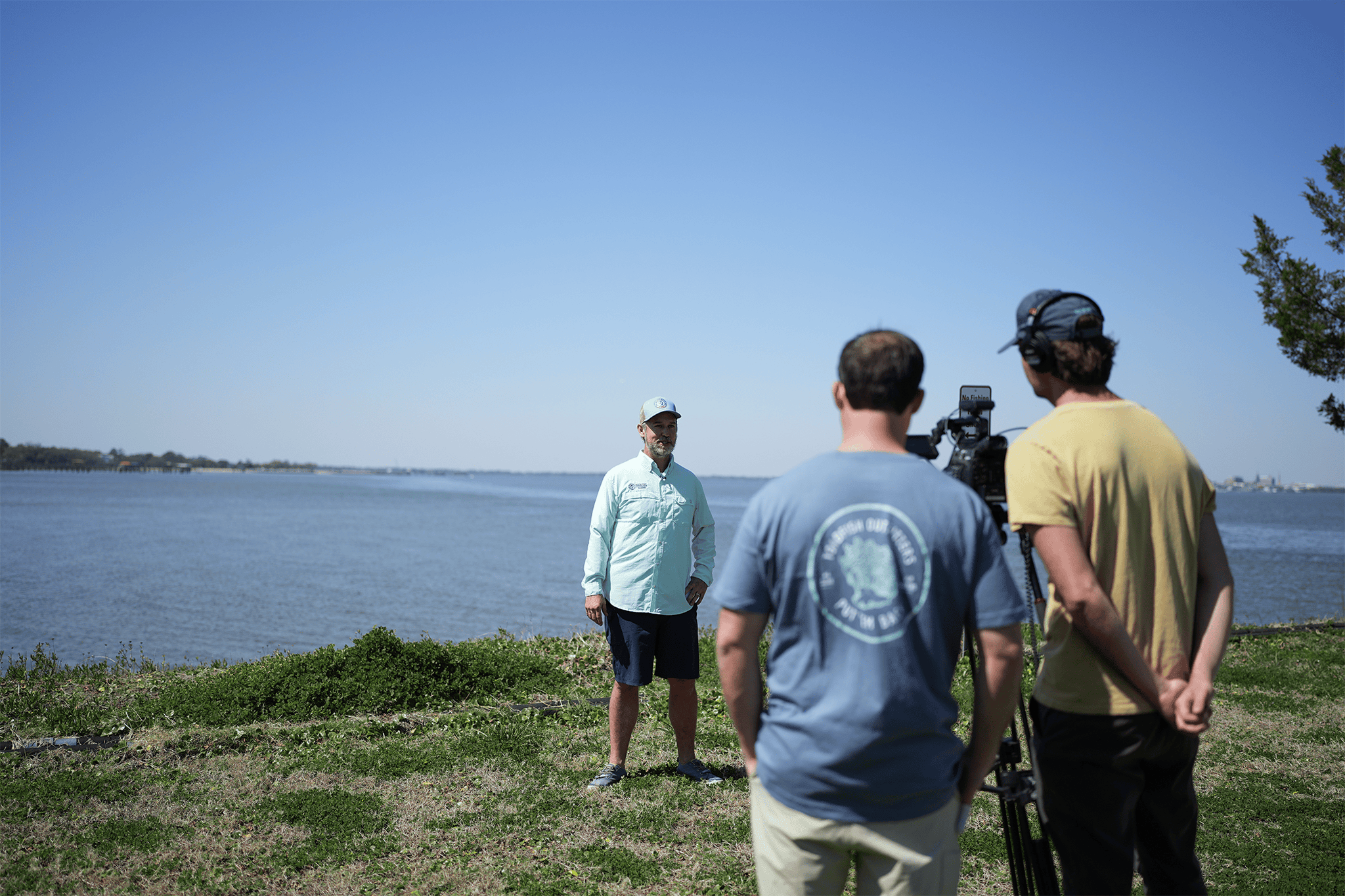 A group of people are at a beach clean-up