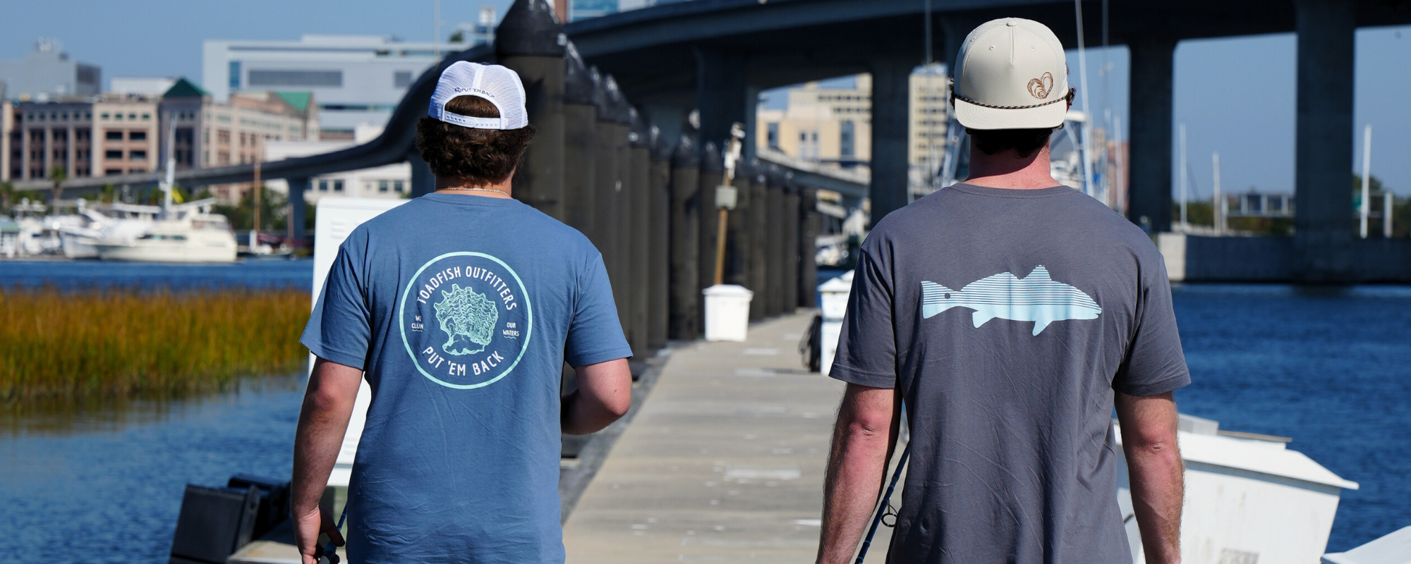 two men are walking wearing toadfish's new tee shirts