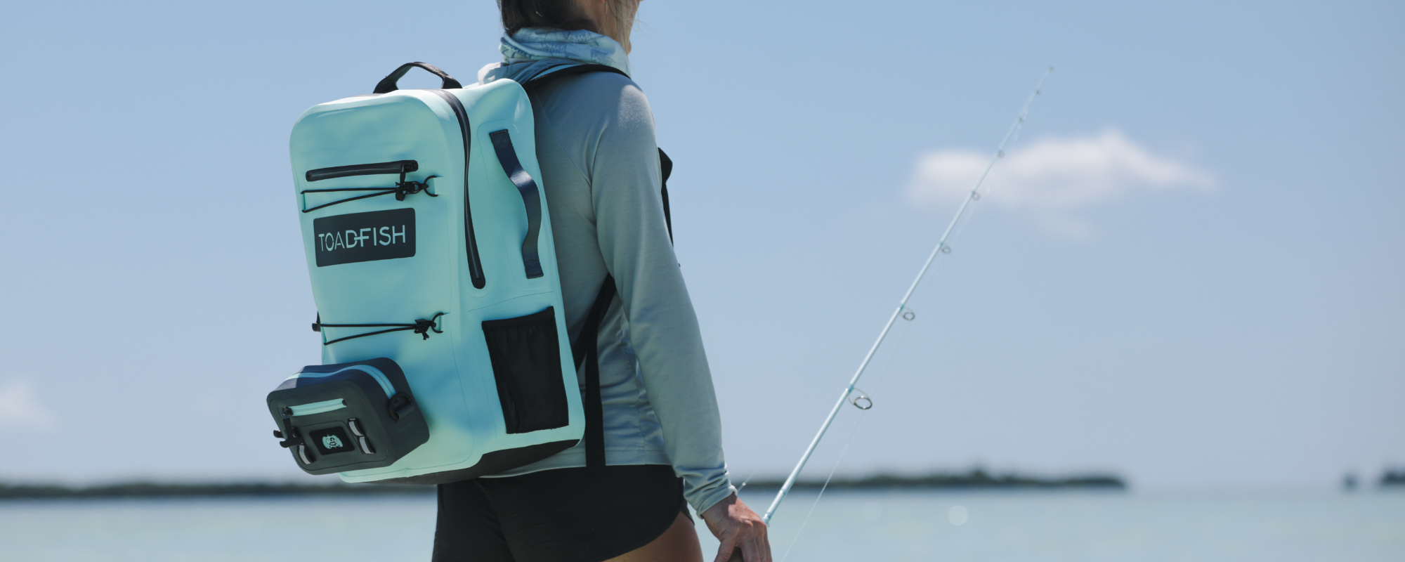 a woman is walking with a toadfish backpack + sling system